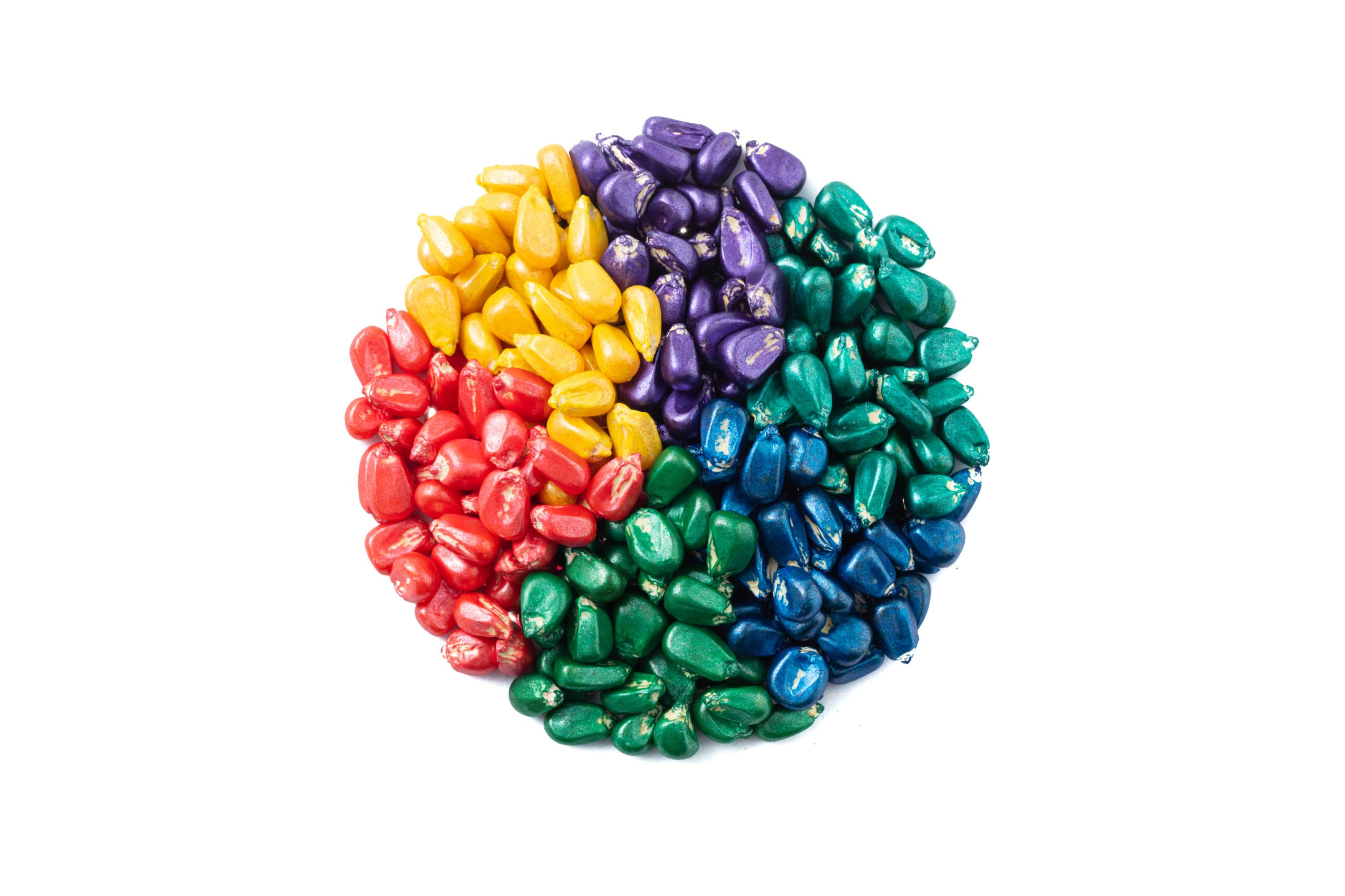 A circle of field crops seeds film coated with colorful Incotec film coats