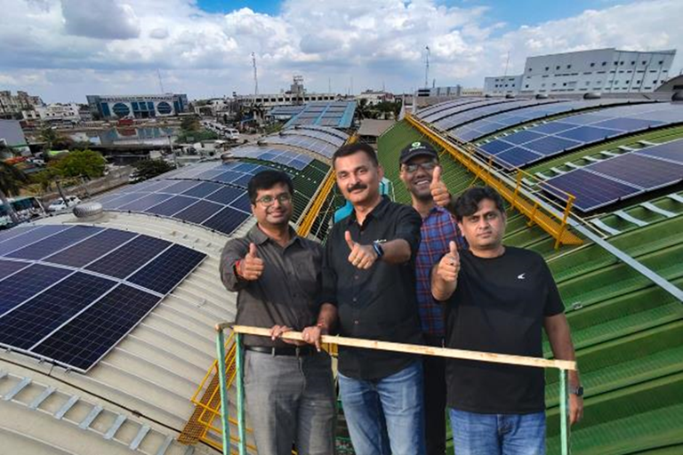 Incotec employees on India facility roof with solar panels